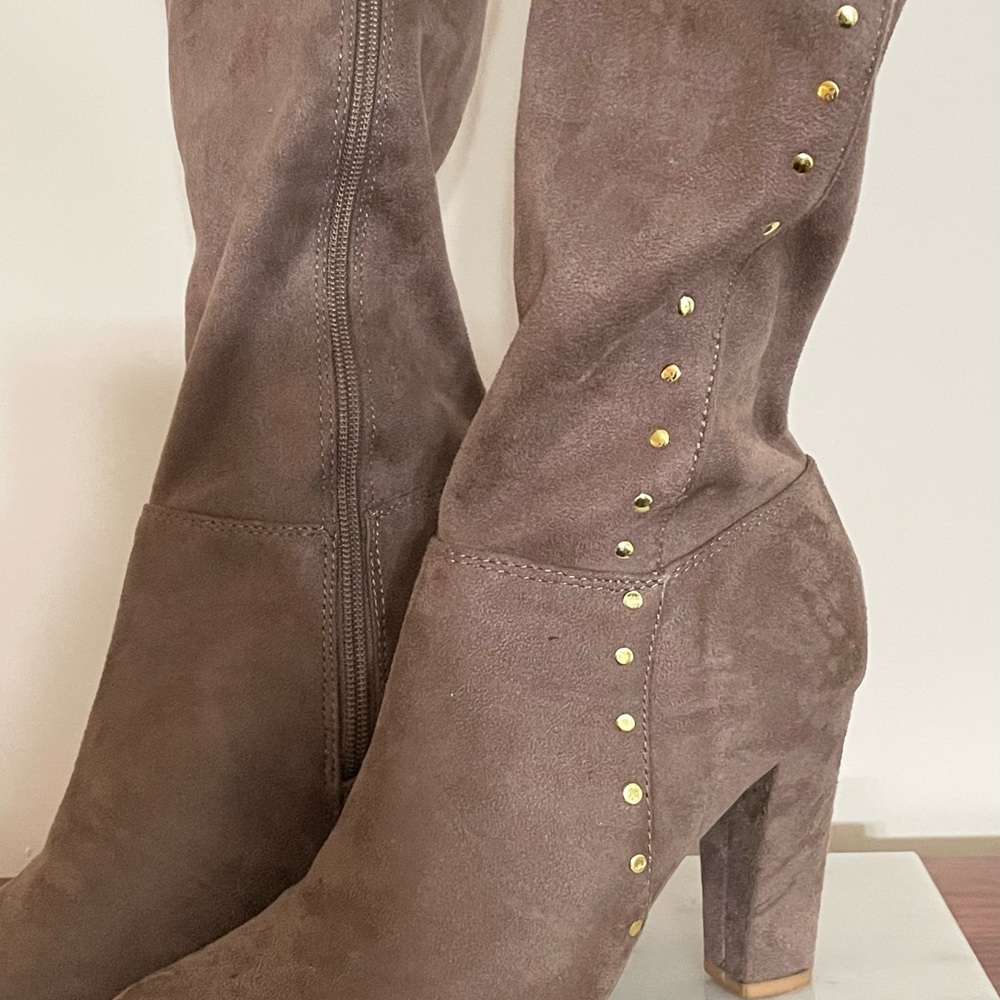 Tan knee high boots.